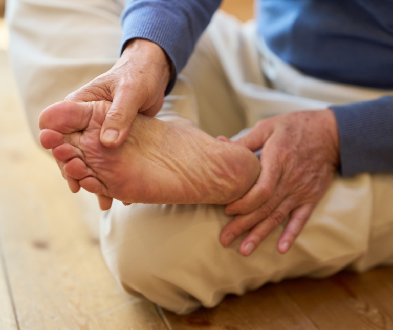 Senior rubbing foot